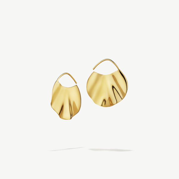 Two gold wavy earrings floating on a white background.