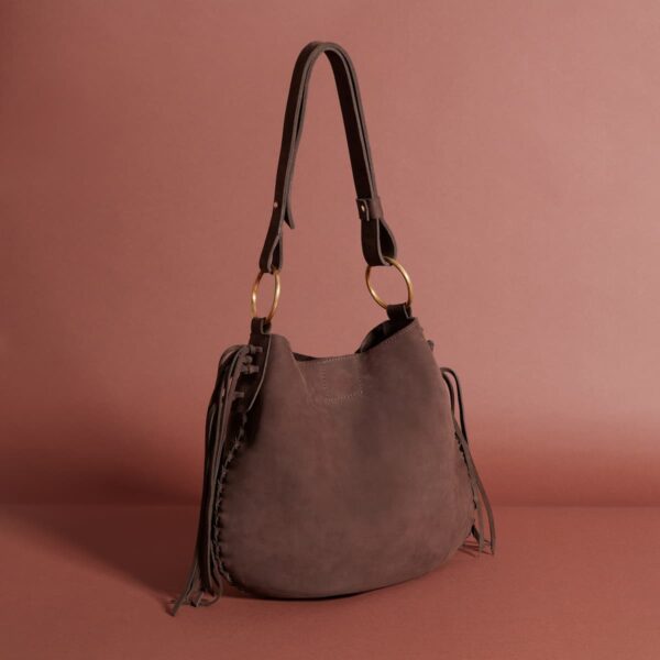 A simple dark brown leather shoulder bag with a shoulder strap and tassels on both sides of the closure