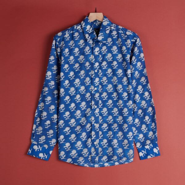 A royal blue long sleeved button up shirt with white patterning