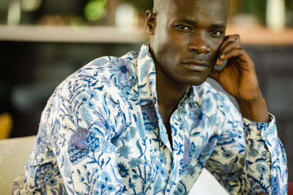 A man wearing a blue and white patterned button up shirt
