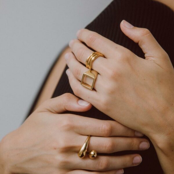 person wearing 24k gold-plated open square ring