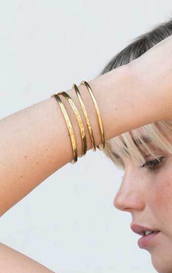 gold bangles on wrist