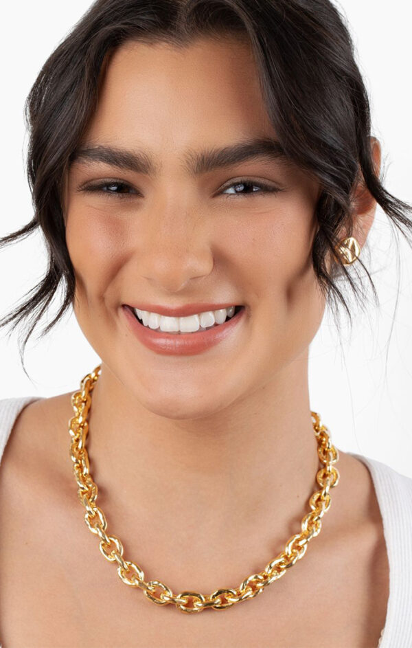 person wearing gold necklace